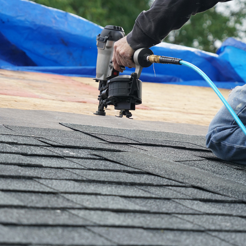 someone repairing shingles