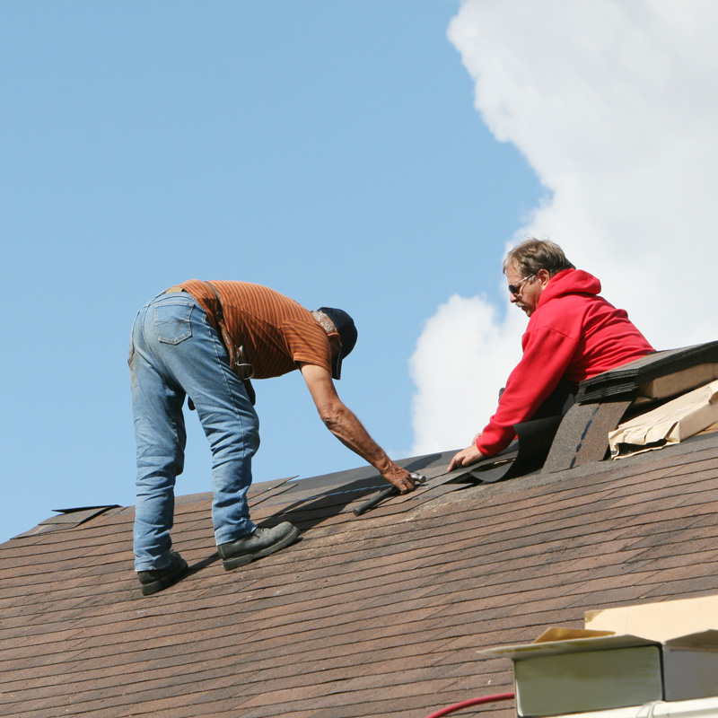 two men working on a roof
